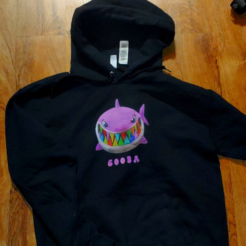 Smiling shark , on front, horse girl on back.